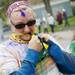 A participant uses her teeth to tear open a powder packet during the Ypsilanti Color Run on Saturday, May 11. Daniel Brenner I AnnArbor.com